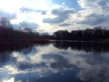 Scenic view of lake against sky at sunset