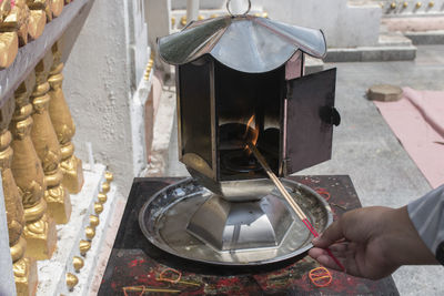 Midsection of person holding ice cream in temple