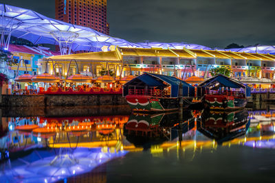 Clarke quay , singapore apr 2020 reflection of illuminated buildings in water at night