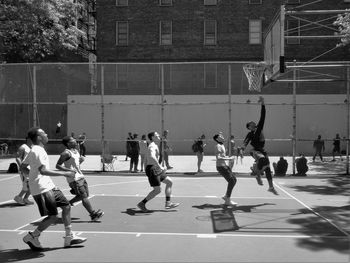 Men playing basketball at court