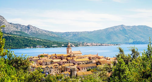 Scenic view of lake and mountains against sky