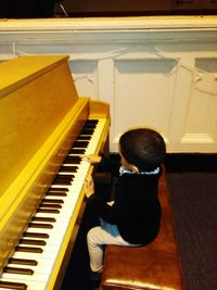 Close-up of boy playing piano