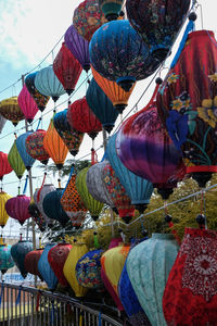 Low angle view of lanterns hanging against sky