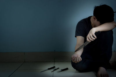 Man sitting on wall at home