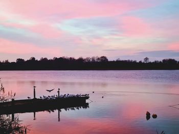 Scenic view of lake against sky during sunset