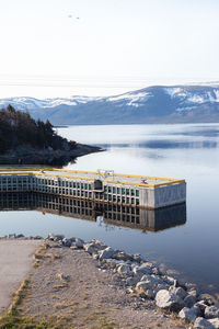 Scenic view of lake against sky during winter