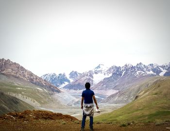 Rear view of woman standing on mountain