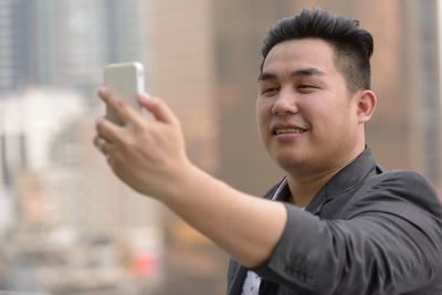 Smiling man doing selfie outdoors