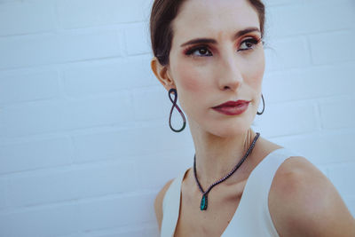 Portrait of woman against wall