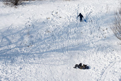 High angle view of people on snow covered field