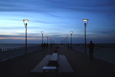 Pier on sea at sunset