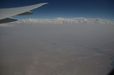 Aerial view of snowcapped mountains against sky