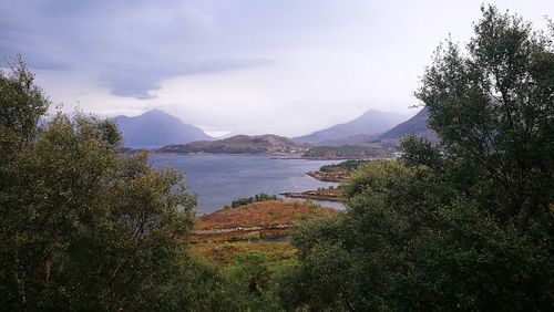 Scenic view of lake and mountains against sky