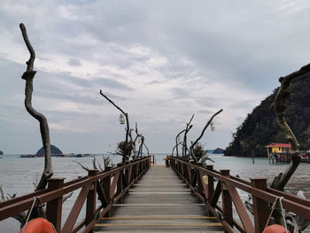 Pier over sea against sky