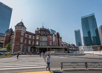 People walking in front of tokyo station against clear sky