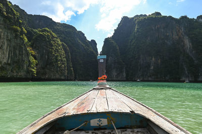 Boats in sea against mountain