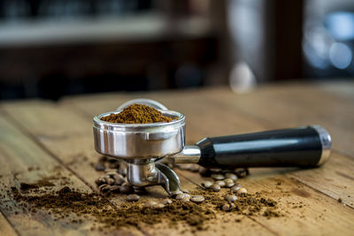 A tamper with ground coffee