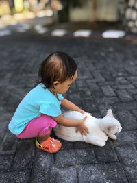 Cute baby girl on footpath