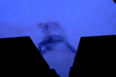 Low angle view of silhouette woman against sky