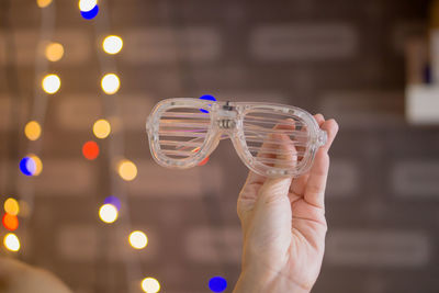 Close-up of hand holding glass against blurred background