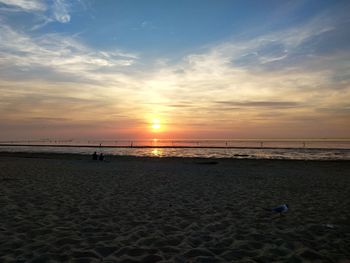 Scenic view of beach against sky during sunset