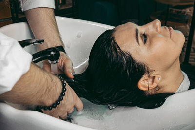 Close-up of man washing hands
