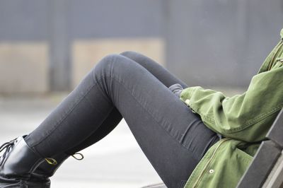 Low section of woman sitting on seat