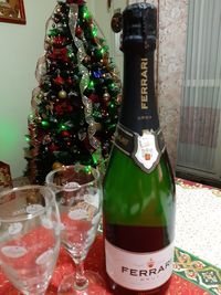 Close-up of wine in glass on illuminated christmas tree