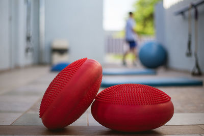 Close-up of red exercise equipment on table at gym