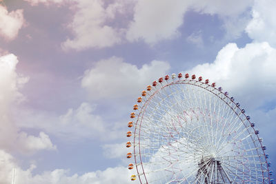 Low angle view of ferris wheel against sky