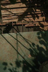 High angle view of shadow on wooden wall