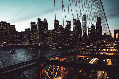 View of bridge over river against buildings in city