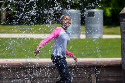 Girl being splashed with water