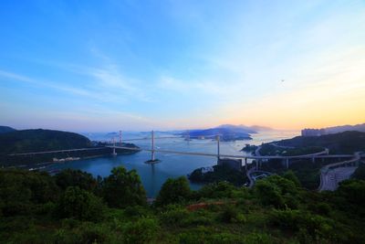 View of bridge over river against cloudy sky