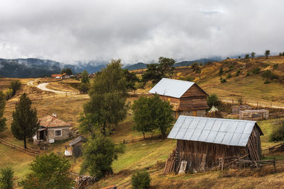 Houses on field against sky