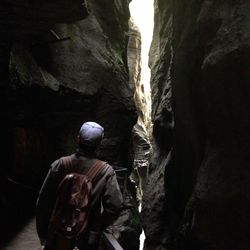 Rear view of man in cave