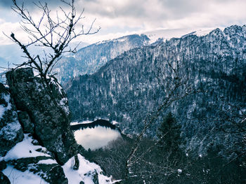 View in the snowy vosges, france, with mountains and a small lake in the valley