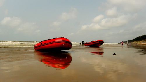 View of boats on beach against sky