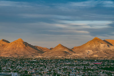 View of desert against cloudy sky