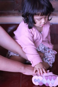 High angle view of girl sitting on floor at home