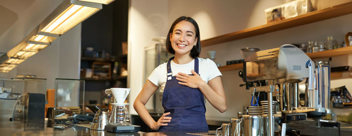 Portrait of young woman using mobile phone at home