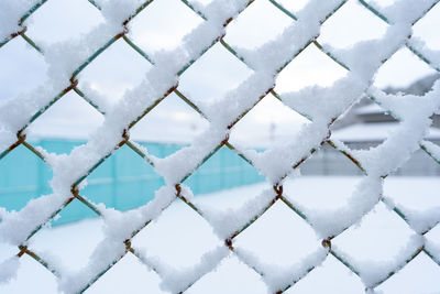 Full frame shot of snow covered fence during winter