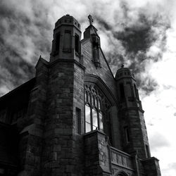 Low angle view of building against cloudy sky