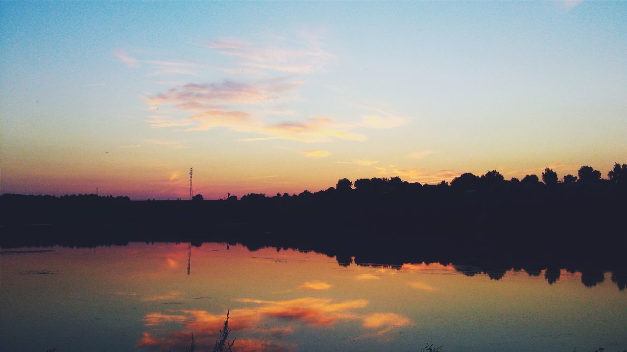 sunset, silhouette, reflection, water, sky, waterfront, scenics, tranquil scene, tranquility, lake, beauty in nature, orange color, nature, standing water, river, built structure, dusk, idyllic, cloud - sky, architecture