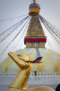 Nepal, bagmati province, kathmandu, gold colored animal sculpture at boudhanath stupa