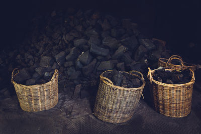 Heap of coals by wicker baskets