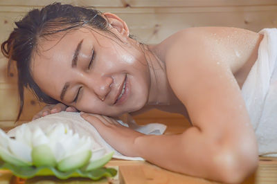 Portrait of a smiling woman lying