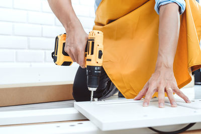 Midsection of woman working on table