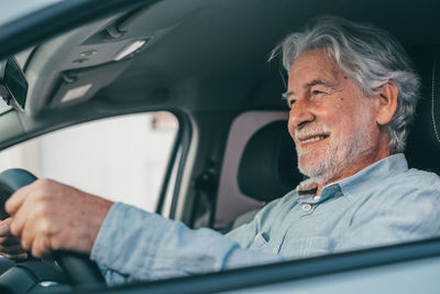 Low angle view of man sitting in car