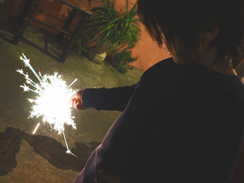 Midsection of man using mobile phone at night